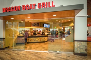 Customers ordering food inside a convention center restaurant.