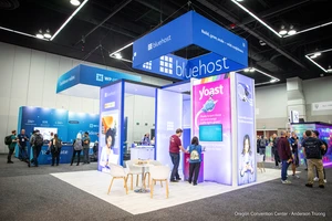 Exhibition booth the convention center. Bright lights, large logos, vibrant colors. Attendees interact with displays, creating a lively atmosphere.
