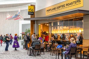 A coffee shop entrance with people.