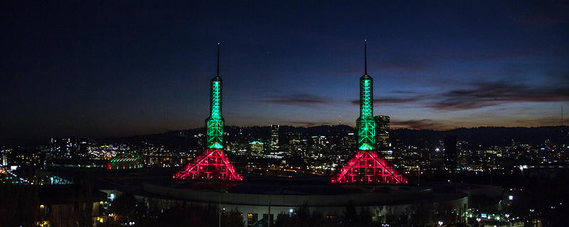 photo of OCC's spire and crescent lights in red and green 