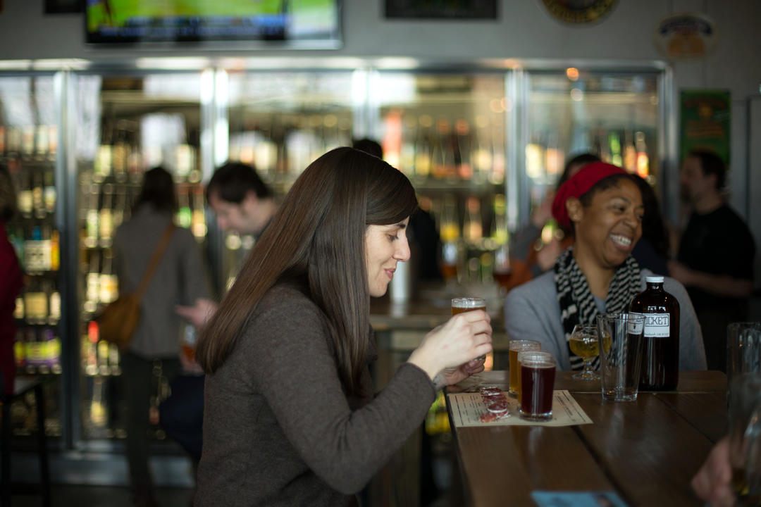 photo of person drinking a beer at a Portland brew pub