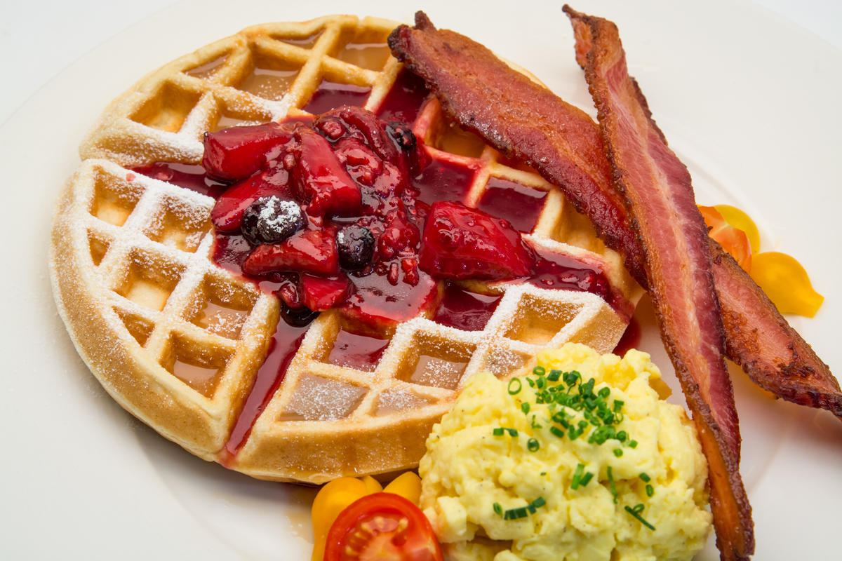 photo of belgium waffle with berry compote and bacon