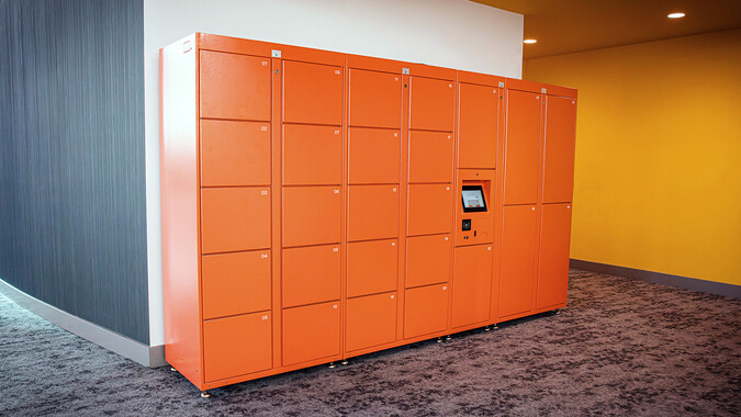 Orange lockers in a lobby.