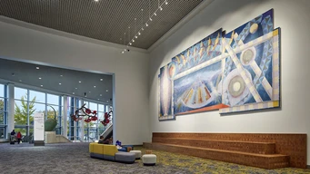 Abstract painting in a large building lobby.