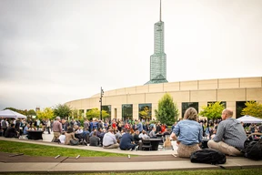 Outdoor gathering with people sitting.