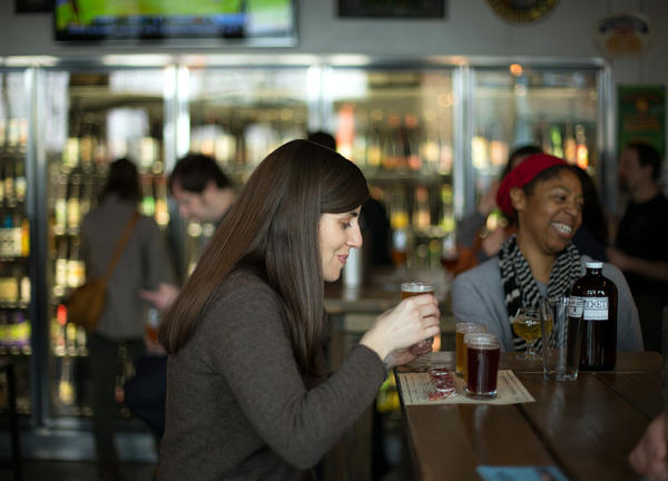photo of person drinking a beer at a Portland brew pub